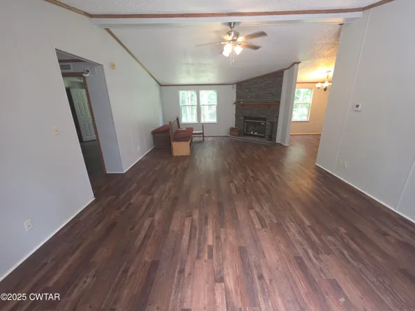 an empty room with windows and cabinet