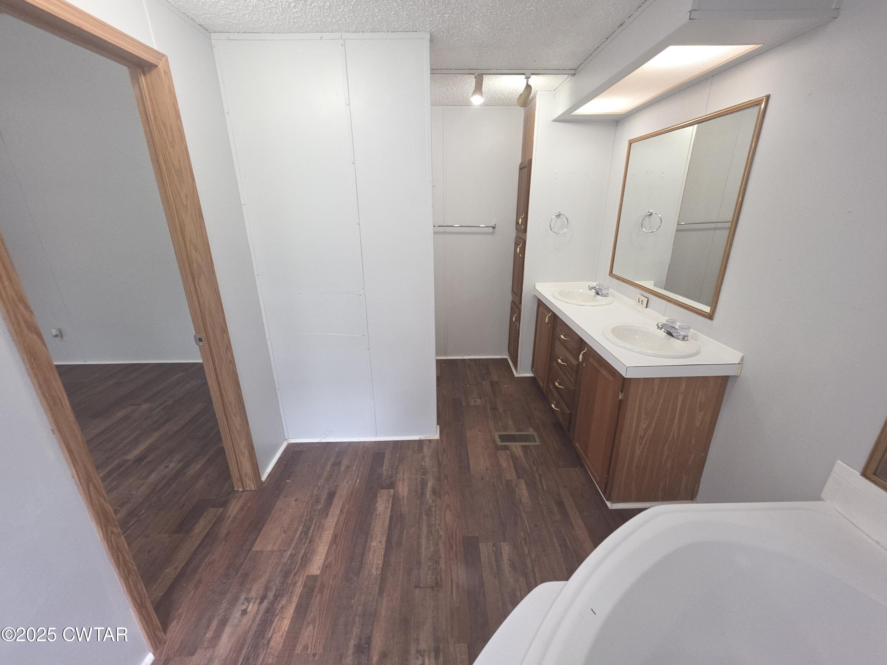 455 Liberty Road Beech Bluff, TN 38313 - Photo 27 of 63 a bathroom with a sink a mirror a toilet and vanity