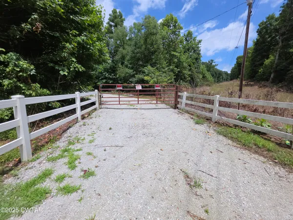 a view of backyard with wooden fence