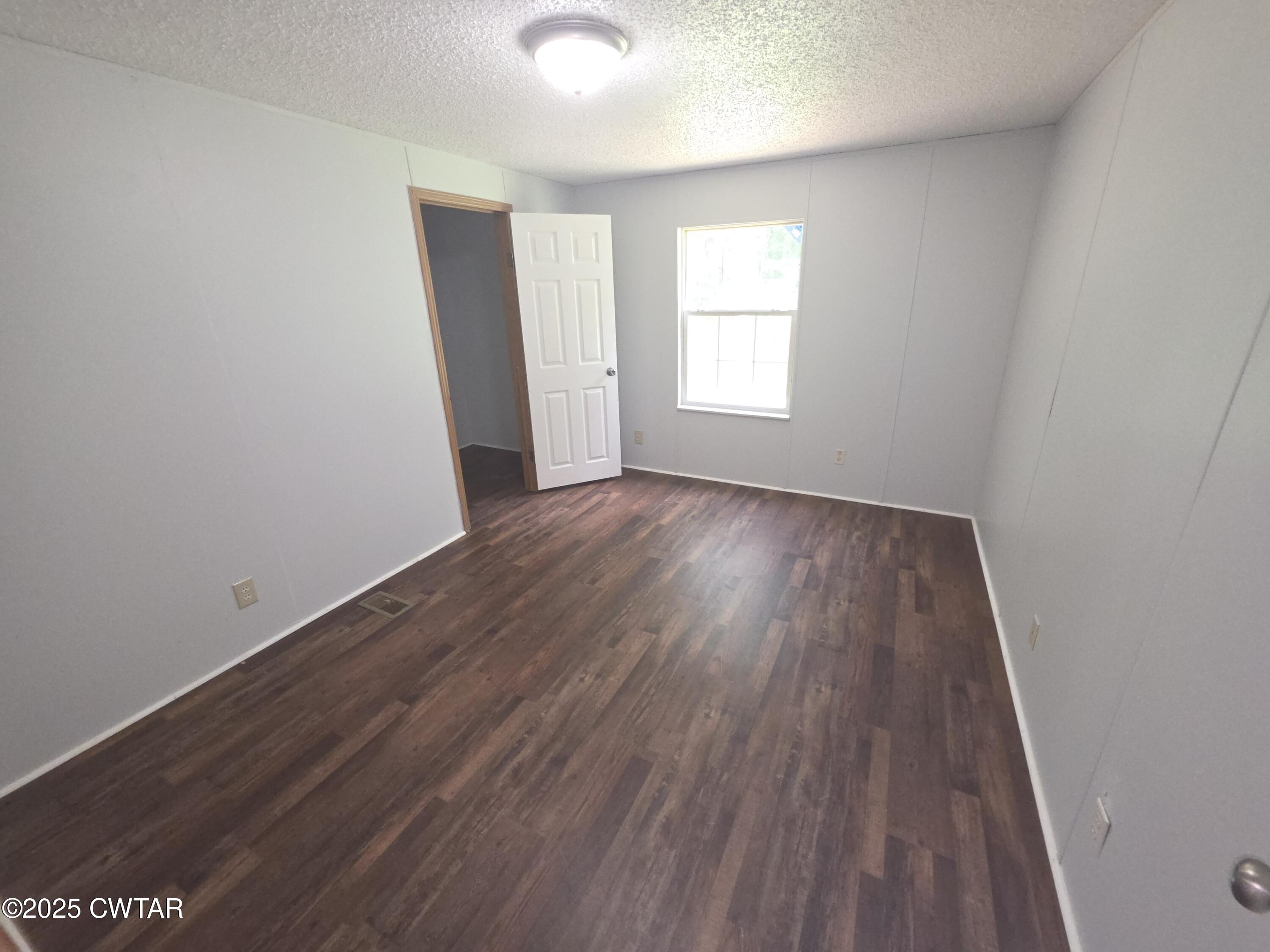 455 Liberty Road Beech Bluff, TN 38313 - Photo 31 of 63 an empty room with wooden floor and windows