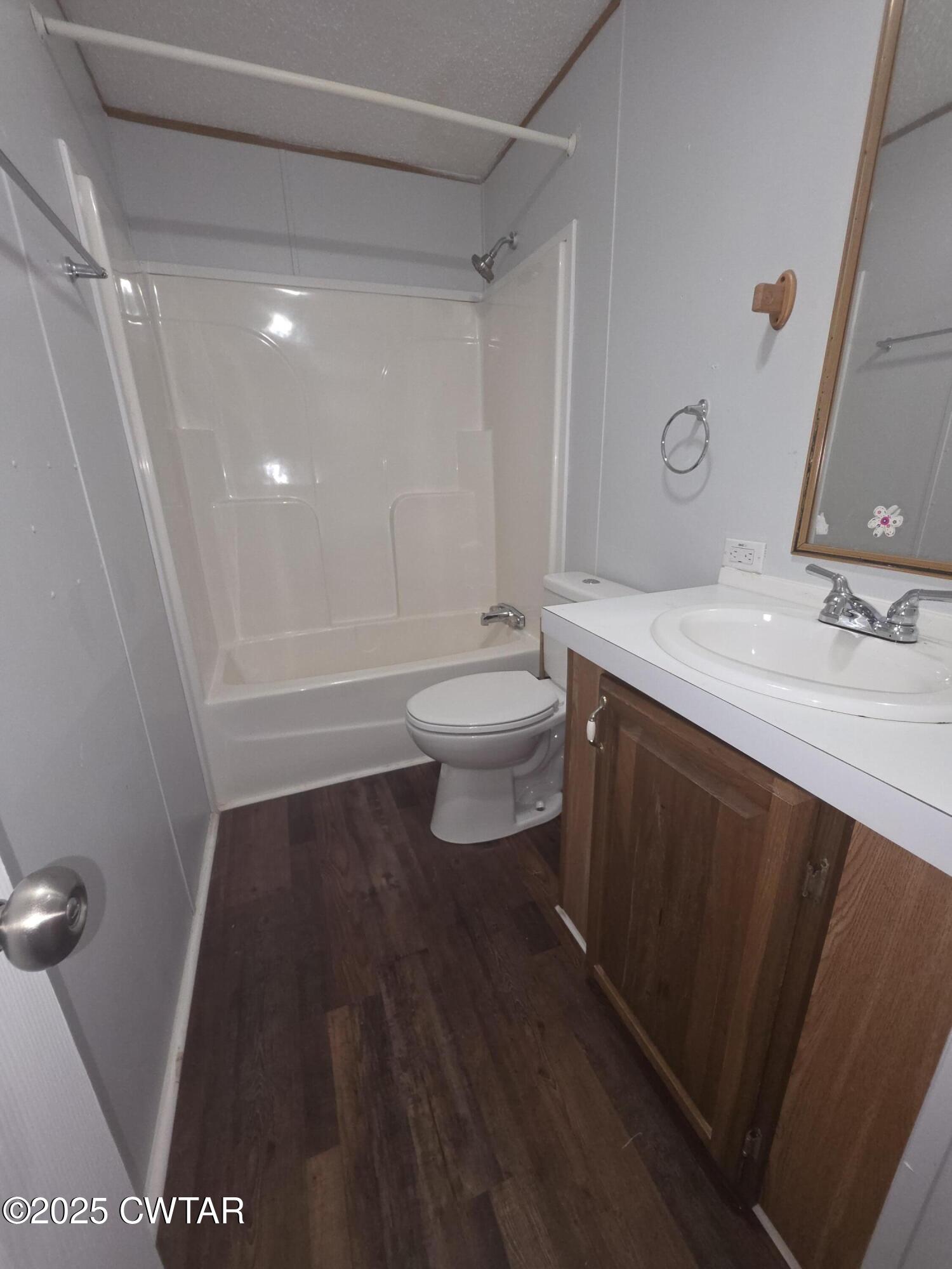 455 Liberty Road Beech Bluff, TN 38313 - Photo 33 of 63 a bathroom with a sink a toilet a mirror and shower