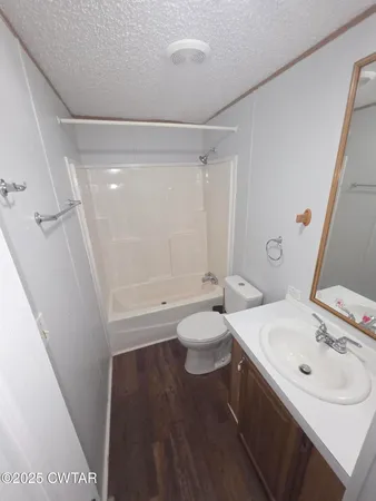 a front view of a house with a garden and trees