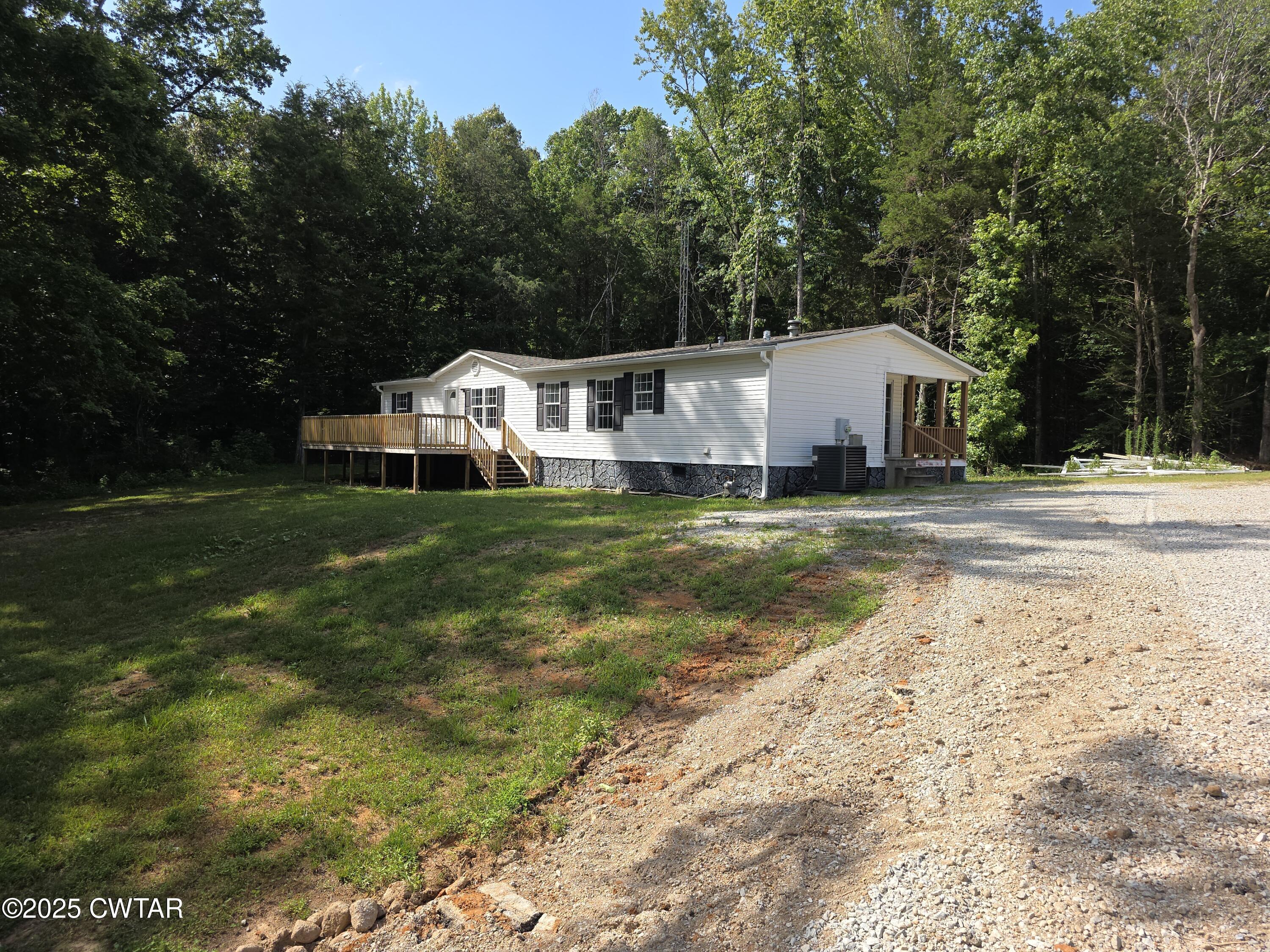 455 Liberty Road Beech Bluff, TN 38313 - Photo 44 of 63 a front view of a house with a garden and trees
