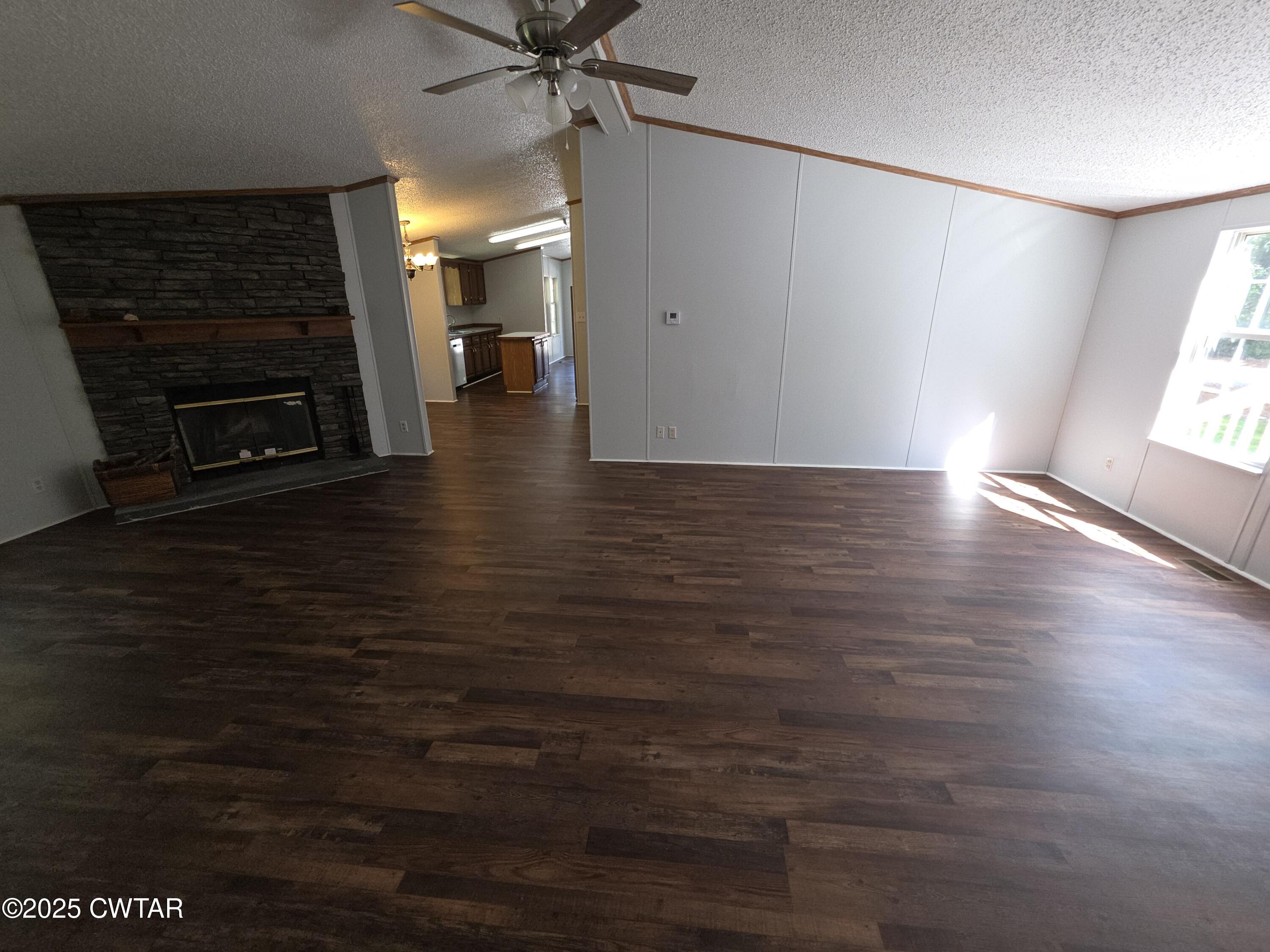 455 Liberty Road Beech Bluff, TN 38313 - Photo 50 of 63 an empty room with wooden floor fireplace and windows