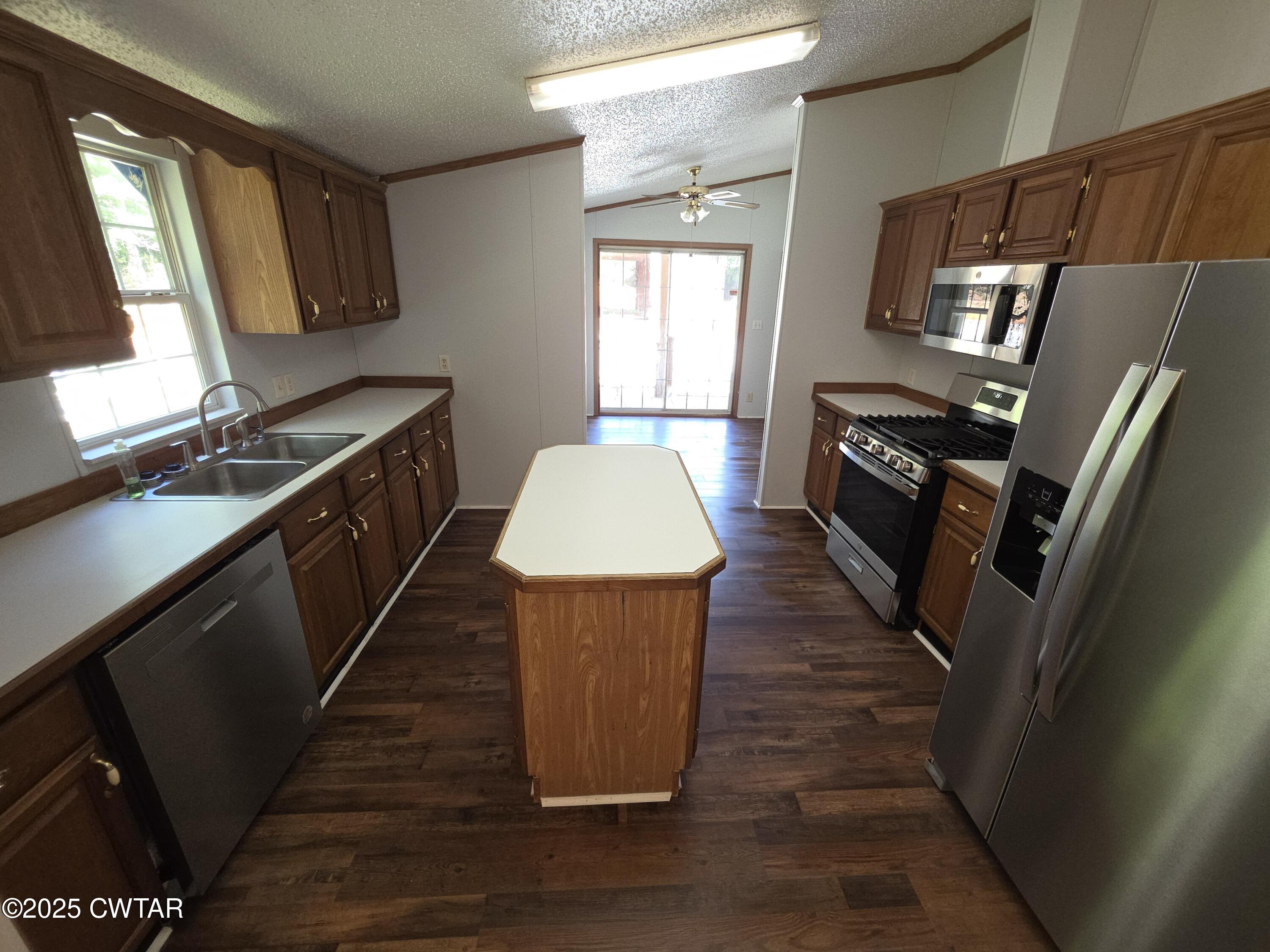 455 Liberty Road Beech Bluff, TN 38313 - Photo 51 of 63 a kitchen with granite countertop a refrigerator a stove top oven a sink and dishwasher