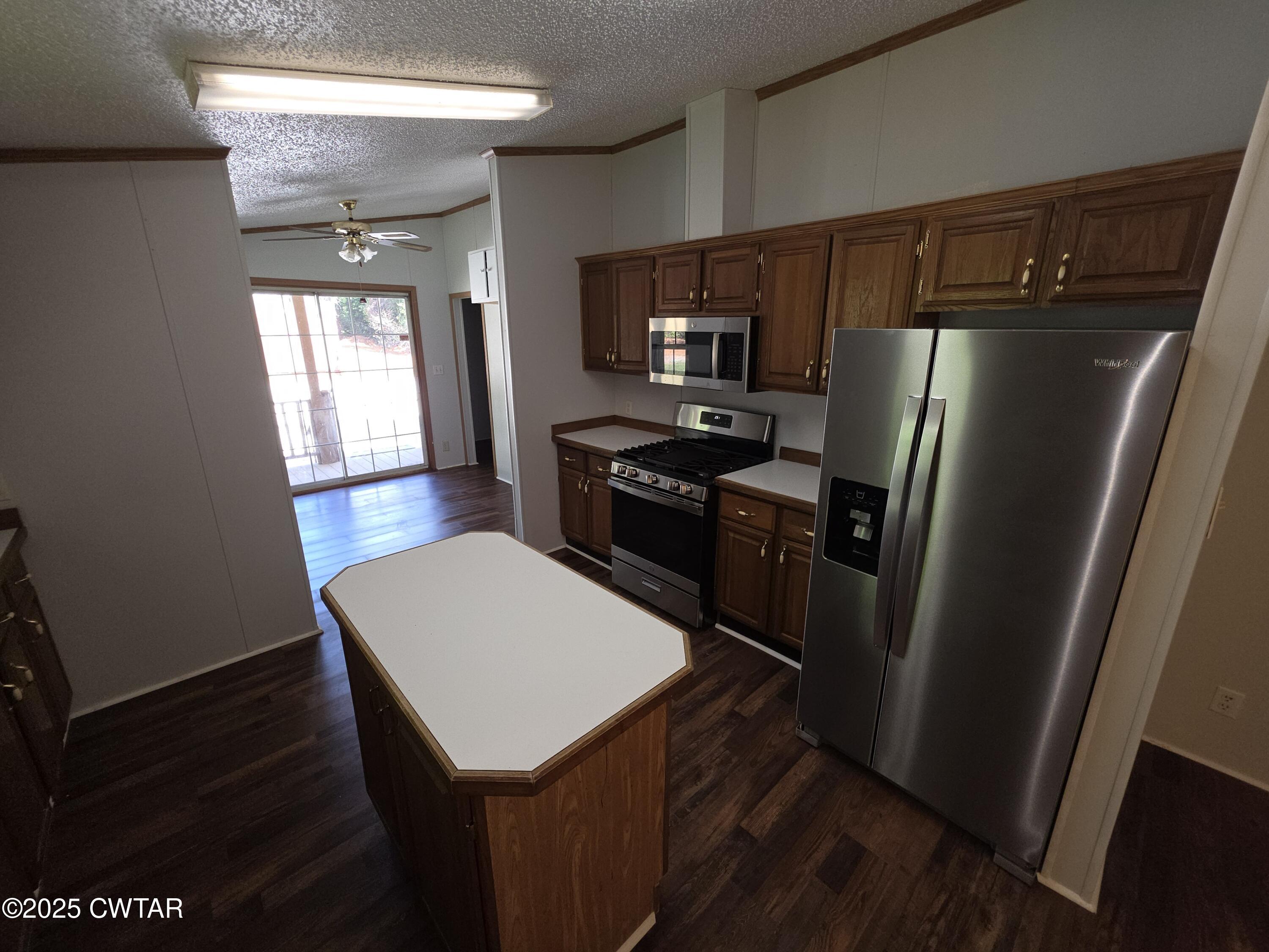 455 Liberty Road Beech Bluff, TN 38313 - Photo 52 of 63 a kitchen with stainless steel appliances a refrigerator a stove a sink and a refrigerator
