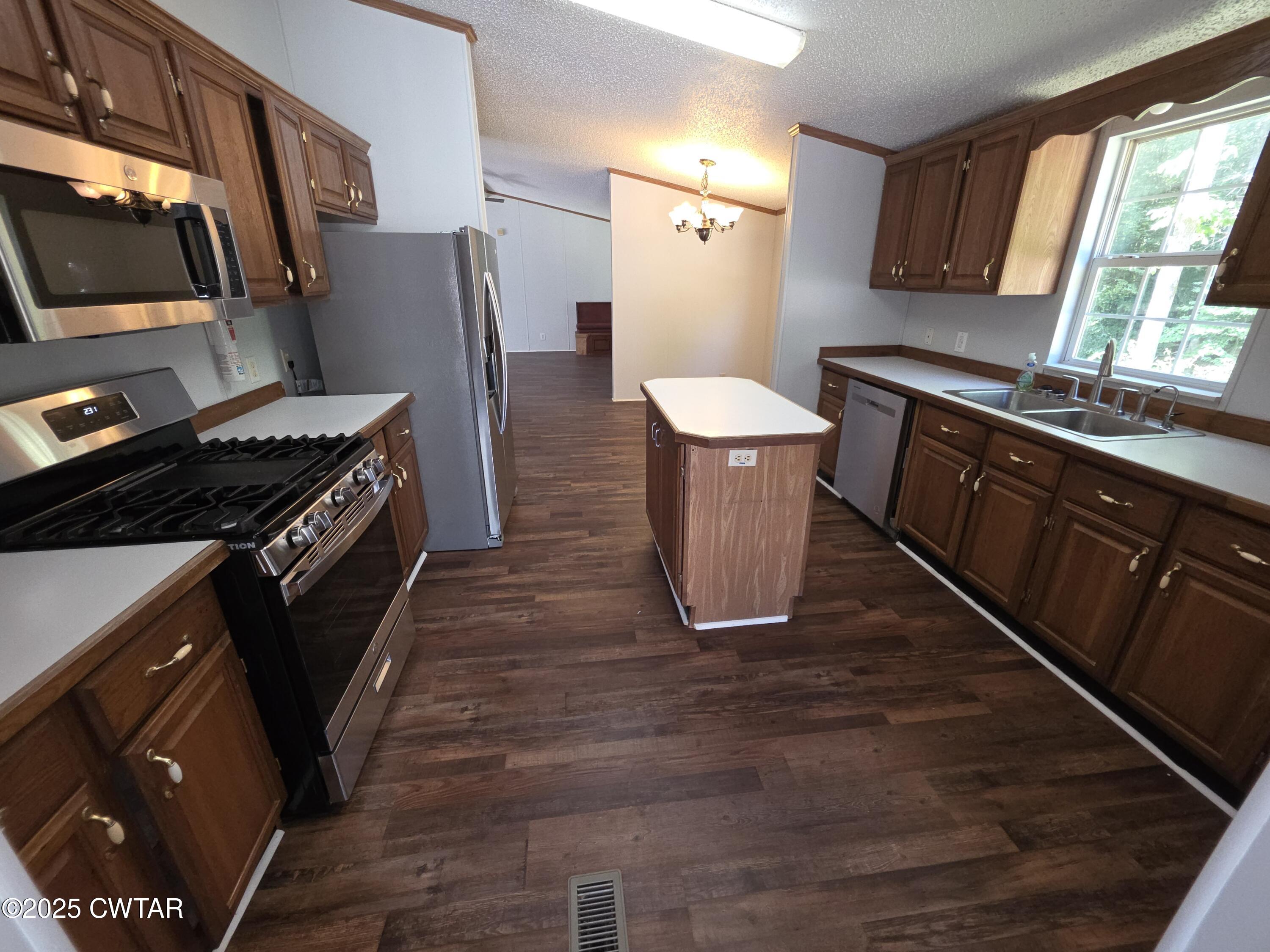 455 Liberty Road Beech Bluff, TN 38313 - Photo 54 of 63 a kitchen with stainless steel appliances a refrigerator a sink a stove and cabinets