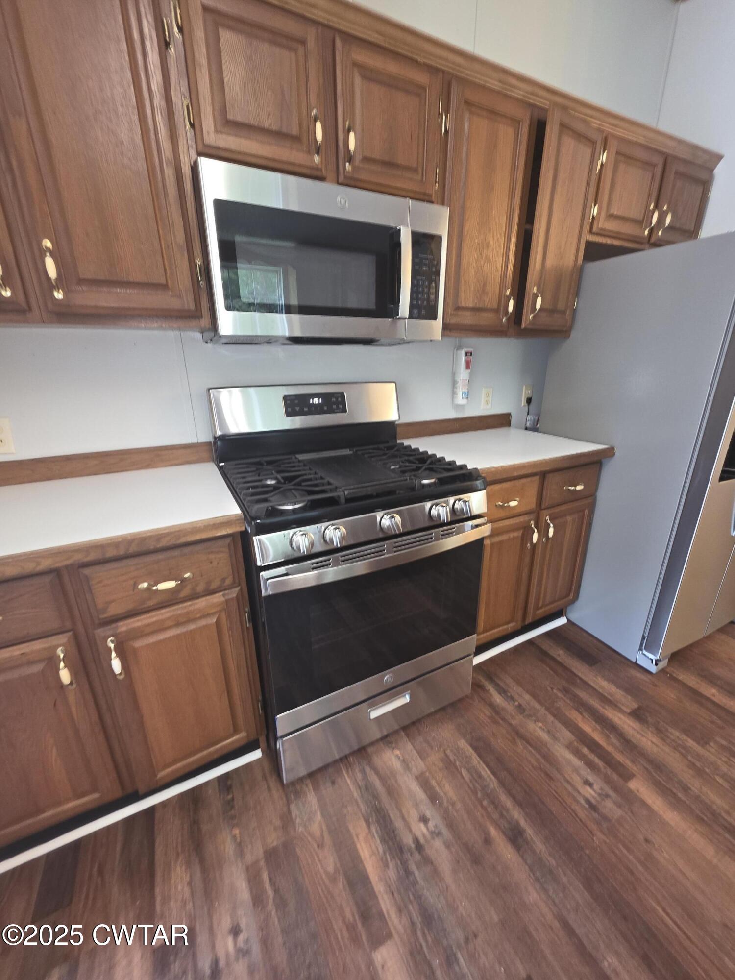 455 Liberty Road Beech Bluff, TN 38313 - Photo 10 of 63 a kitchen with granite countertop wooden cabinets and a stove top oven