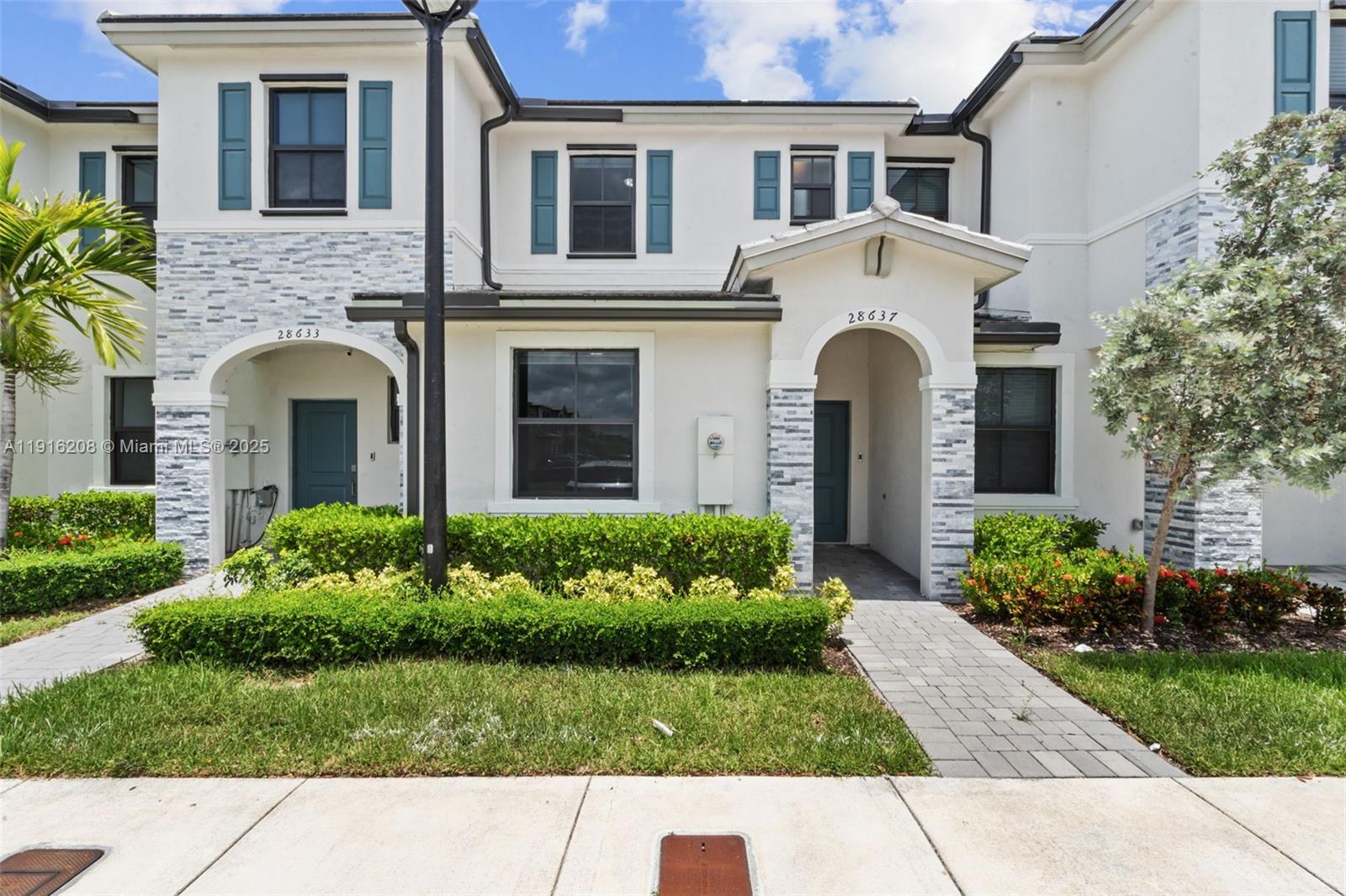 a view of a brick house with a yard