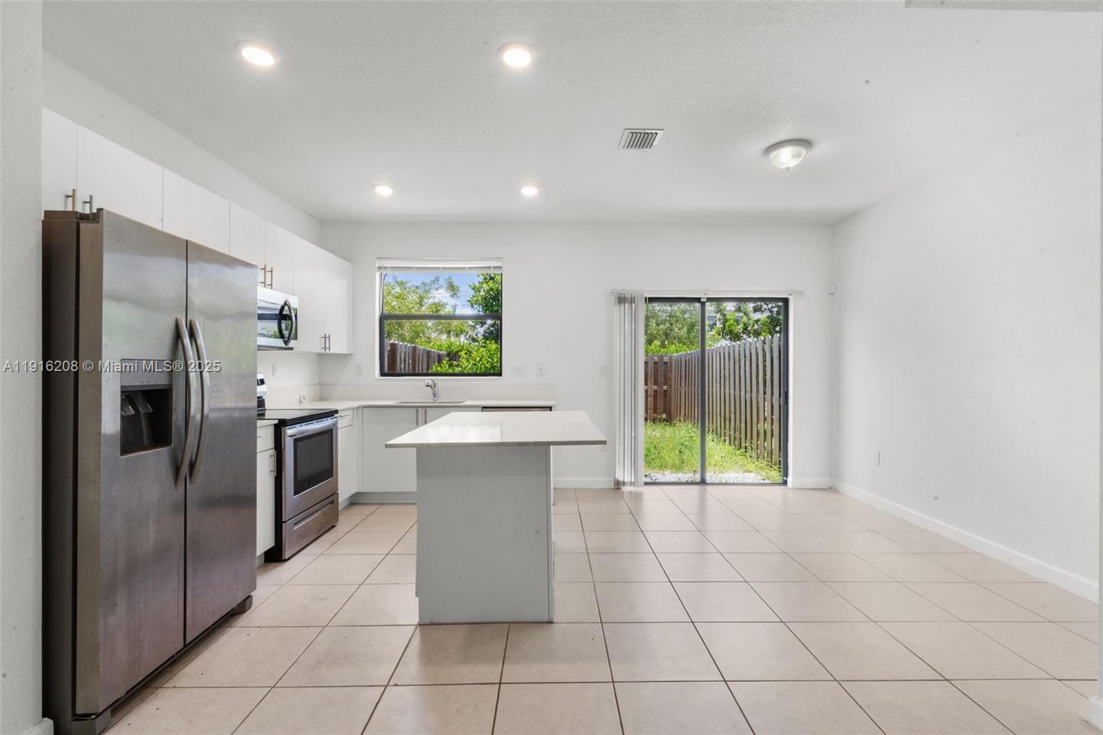 28637 Southwest 132nd Court Homestead, FL 33033 - Photo 15 of 45 a kitchen with stainless steel appliances a refrigerator sink and stove