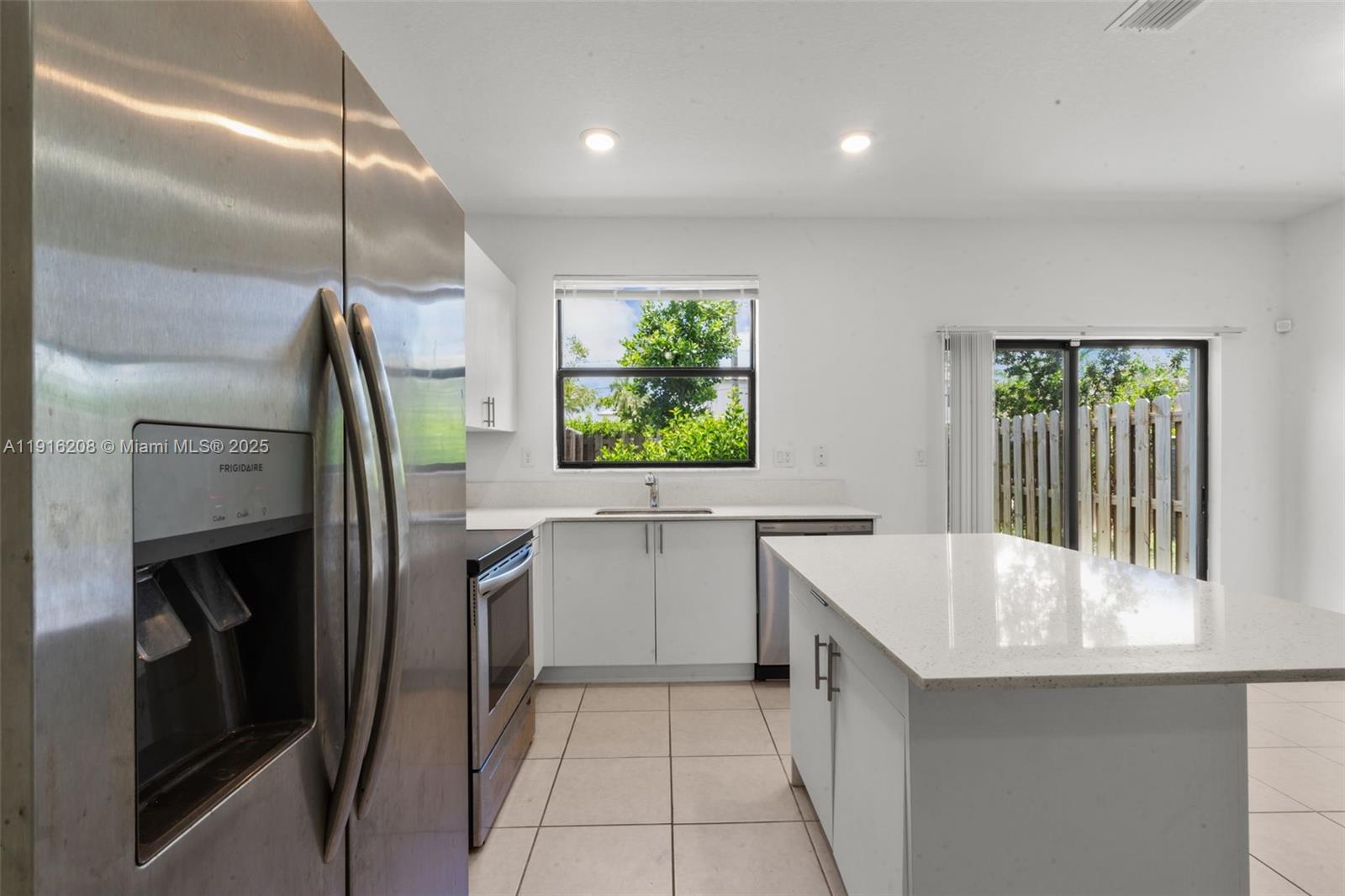 28637 Southwest 132nd Court Homestead, FL 33033 - Photo 17 of 45 a kitchen with a sink and refrigerator