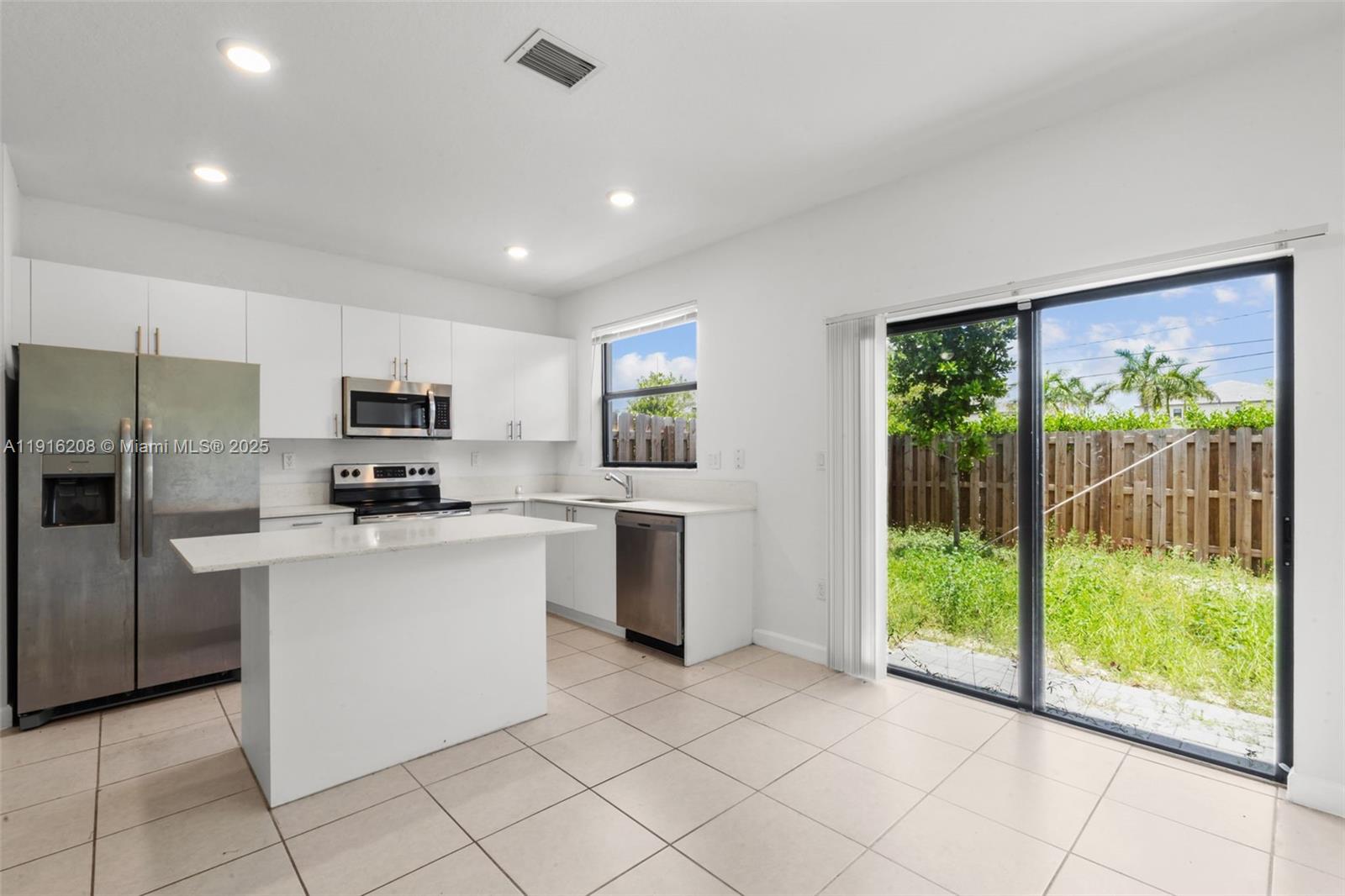 28637 Southwest 132nd Court Homestead, FL 33033 - Photo 18 of 45 a kitchen with stainless steel appliances granite countertop a refrigerator oven a sink and dishwasher