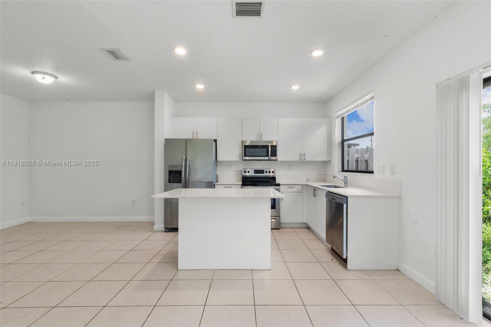 28637 Southwest 132nd Court Homestead, FL 33033 - Photo 19 of 45 a kitchen with a sink and white cabinets
