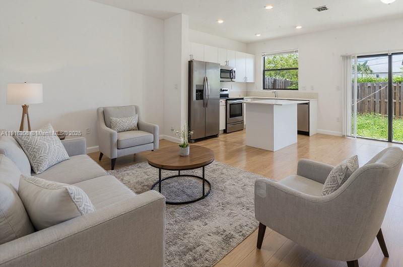 28637 Southwest 132nd Court Homestead, FL 33033 - Photo 10 of 45 a living room with furniture and a kitchen