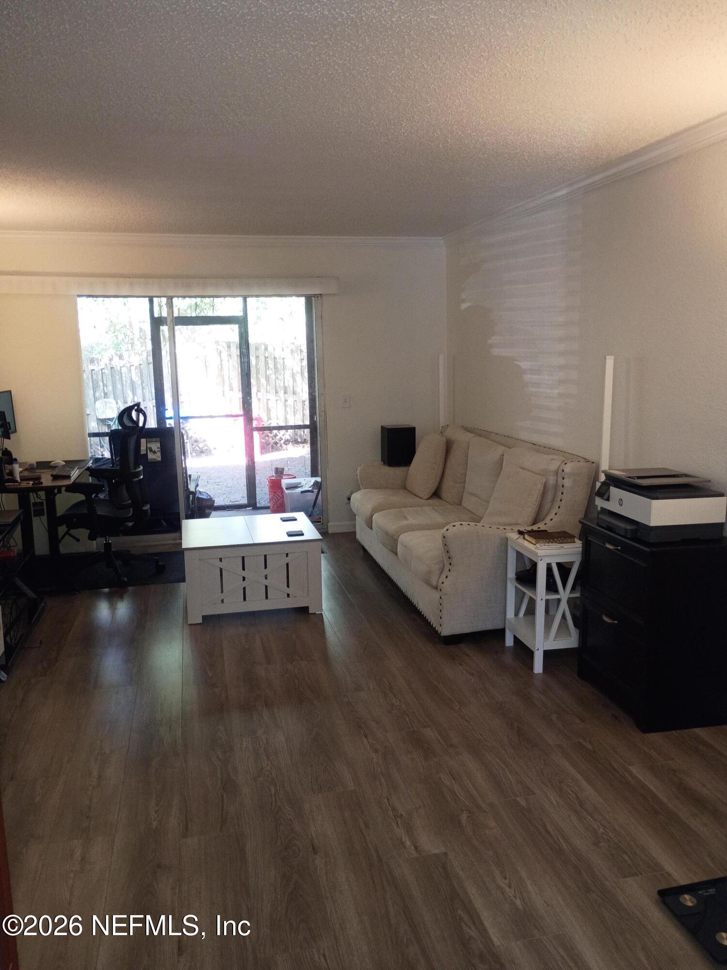 8880 Old Kings Road South, Unit 71 Jacksonville, FL 32257 - Photo 3 of 10 a living room with furniture and a large window