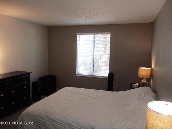 a bedroom with a bed and window