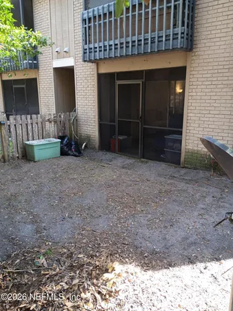 a view of a house with a porch and furniture
