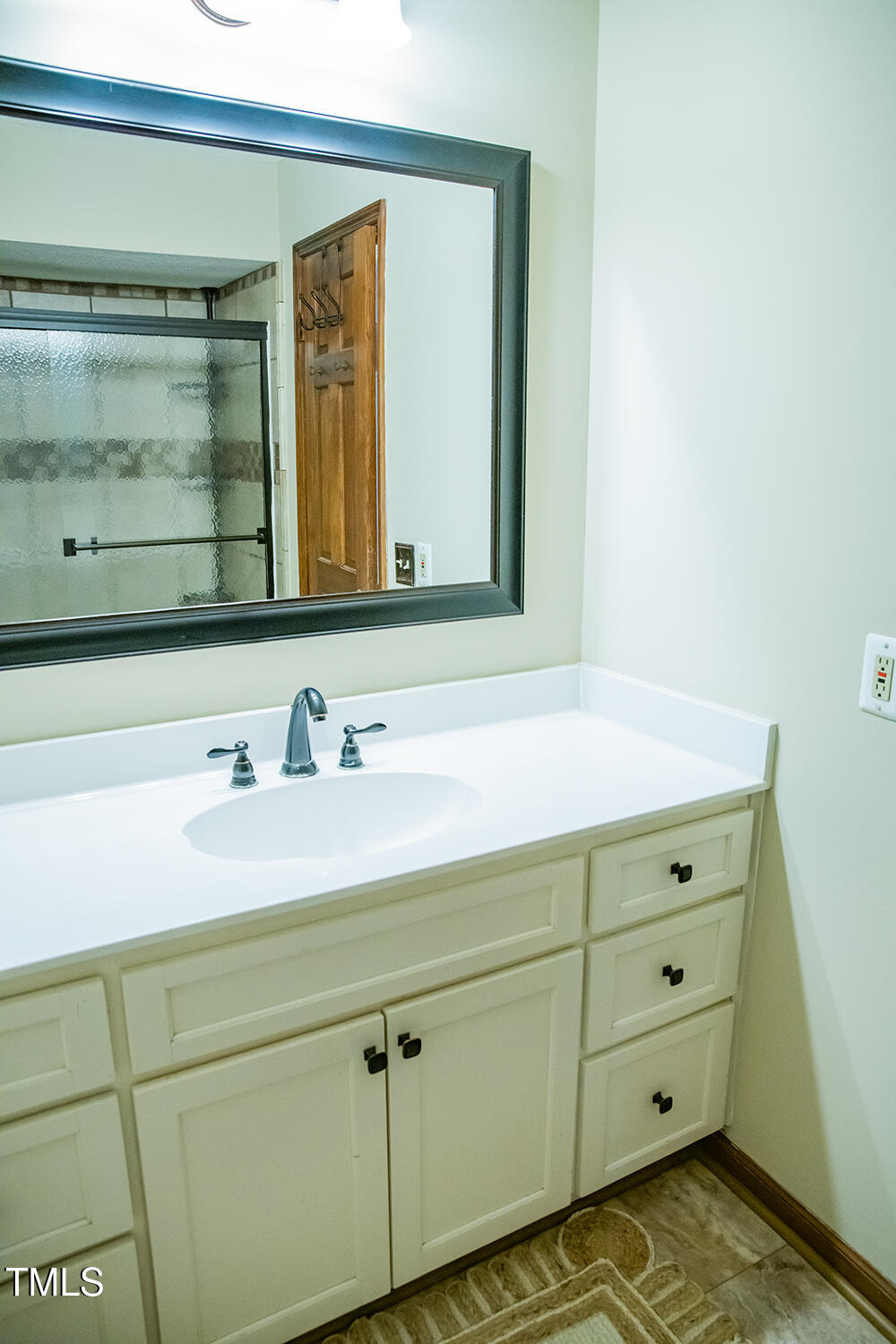 1751 Chub Lake Road Roxboro, NC 27574 - Photo 54 of 93 a bathroom with a sink and a mirror
