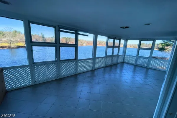 wooden floor in an empty room with a large window