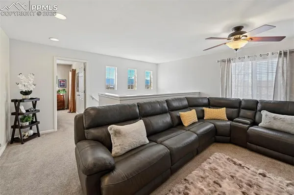 a living room with furniture and a chandelier
