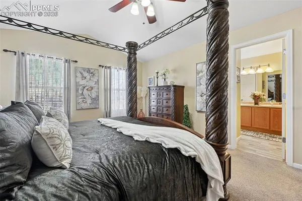 a bedroom with a bed and a view of walk in closet