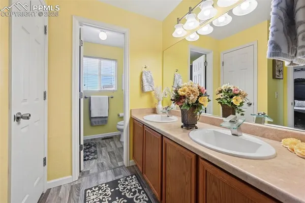 a bathroom with a granite countertop sink a large mirror and a shower