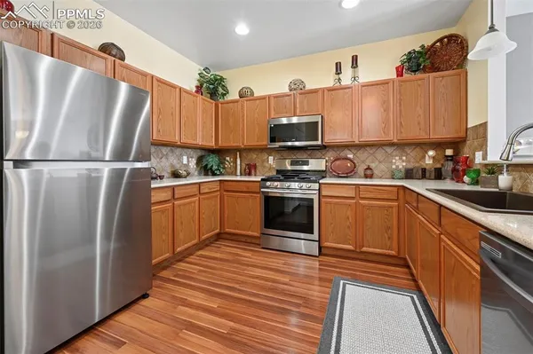 a kitchen with stainless steel appliances a refrigerator sink and cabinets