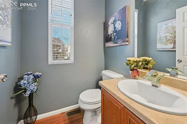 a bathroom with a sink mirror and toilet