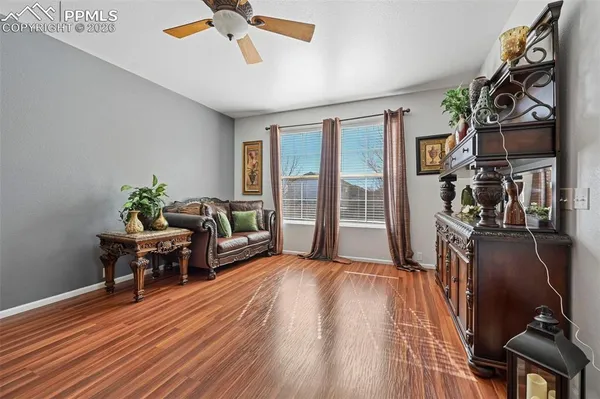 a living room with furniture and wooden floor