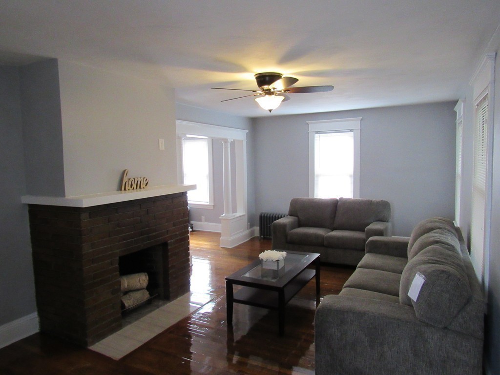 55 Rimmon Avenue Springfield, MA 01107 - Photo 4 of 17 a living room with furniture a fireplace and a chandelier