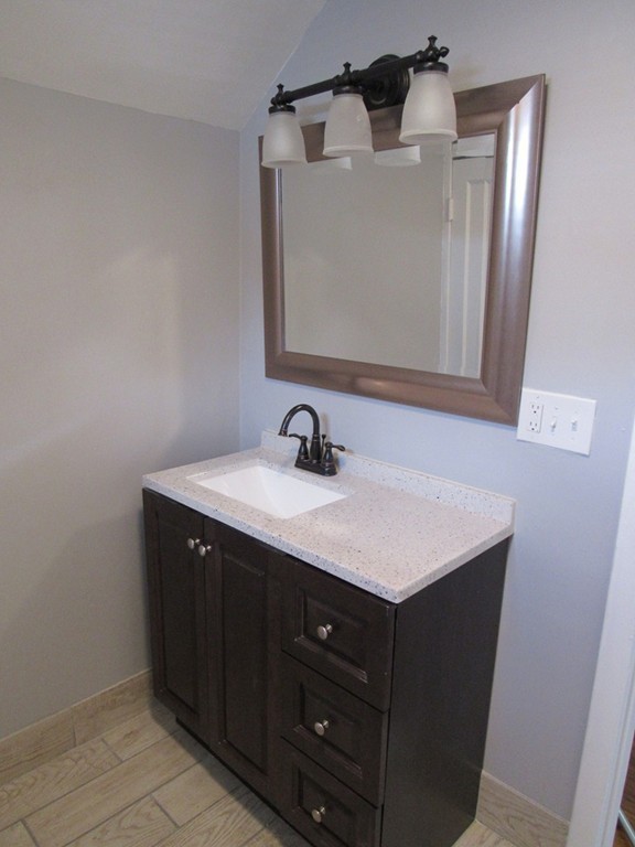 55 Rimmon Avenue Springfield, MA 01107 - Photo 8 of 17 a bathroom with a sink vanity and mirror