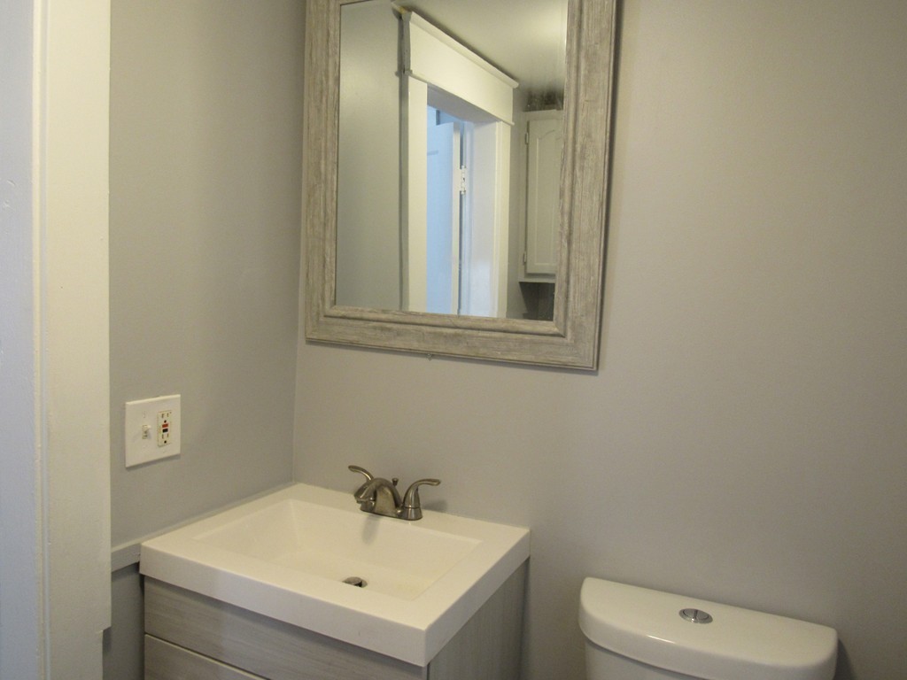 55 Rimmon Avenue Springfield, MA 01107 - Photo 9 of 17 a bathroom with a sink a toilet and mirror