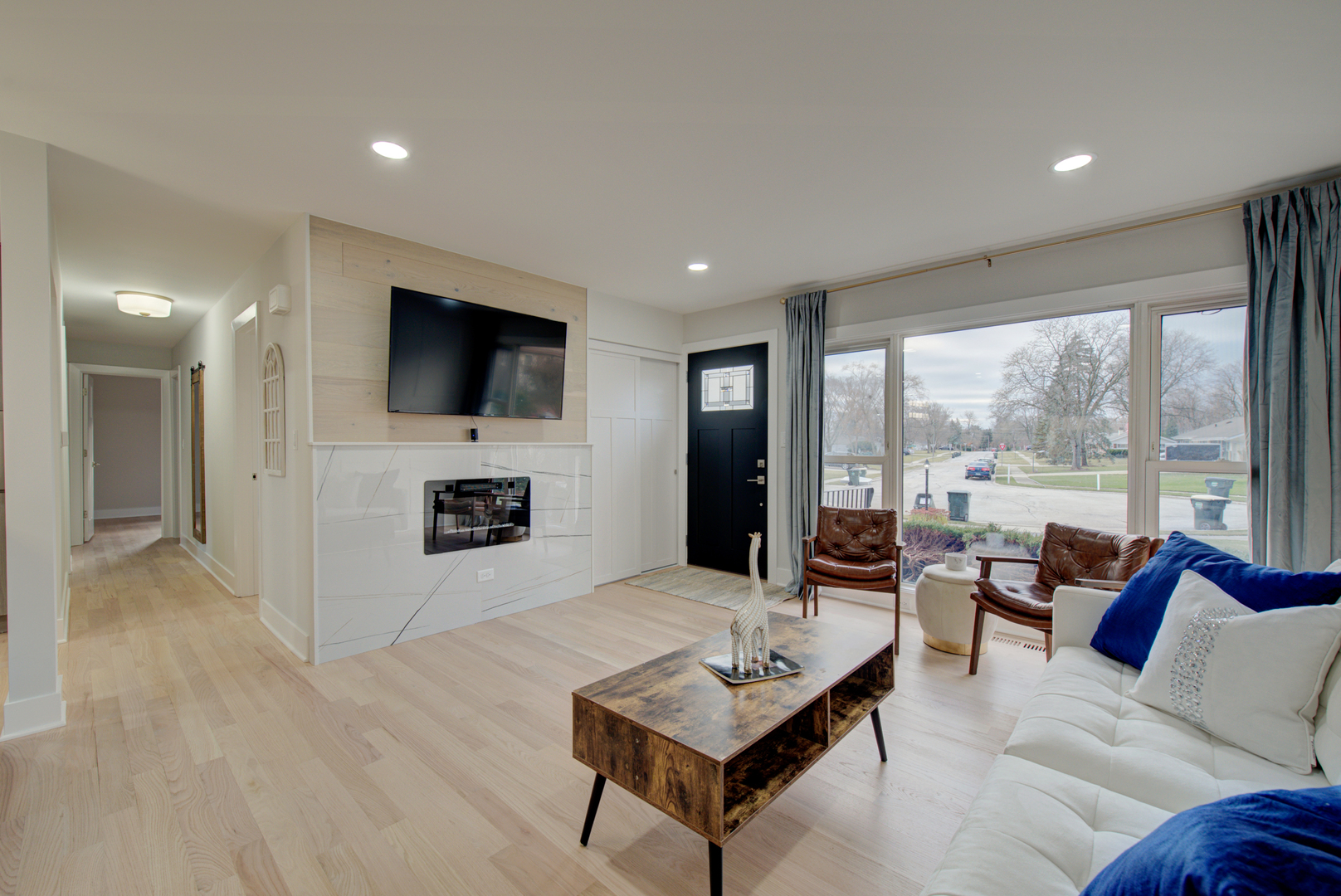 560 Lincoln Drive Hoffman Estates, IL 60169 - Photo 3 of 38 a living room with furniture a fireplace and a flat screen tv
