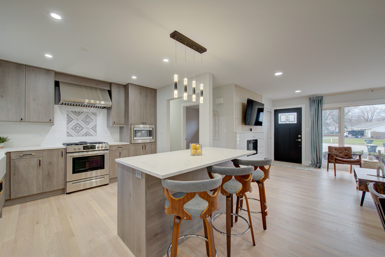560 Lincoln Drive Hoffman Estates, IL 60169 - Photo 8 of 38 a open kitchen with stainless steel appliances kitchen island granite countertop a stove top oven a sink dishwasher a dining table and chairs with wooden floor