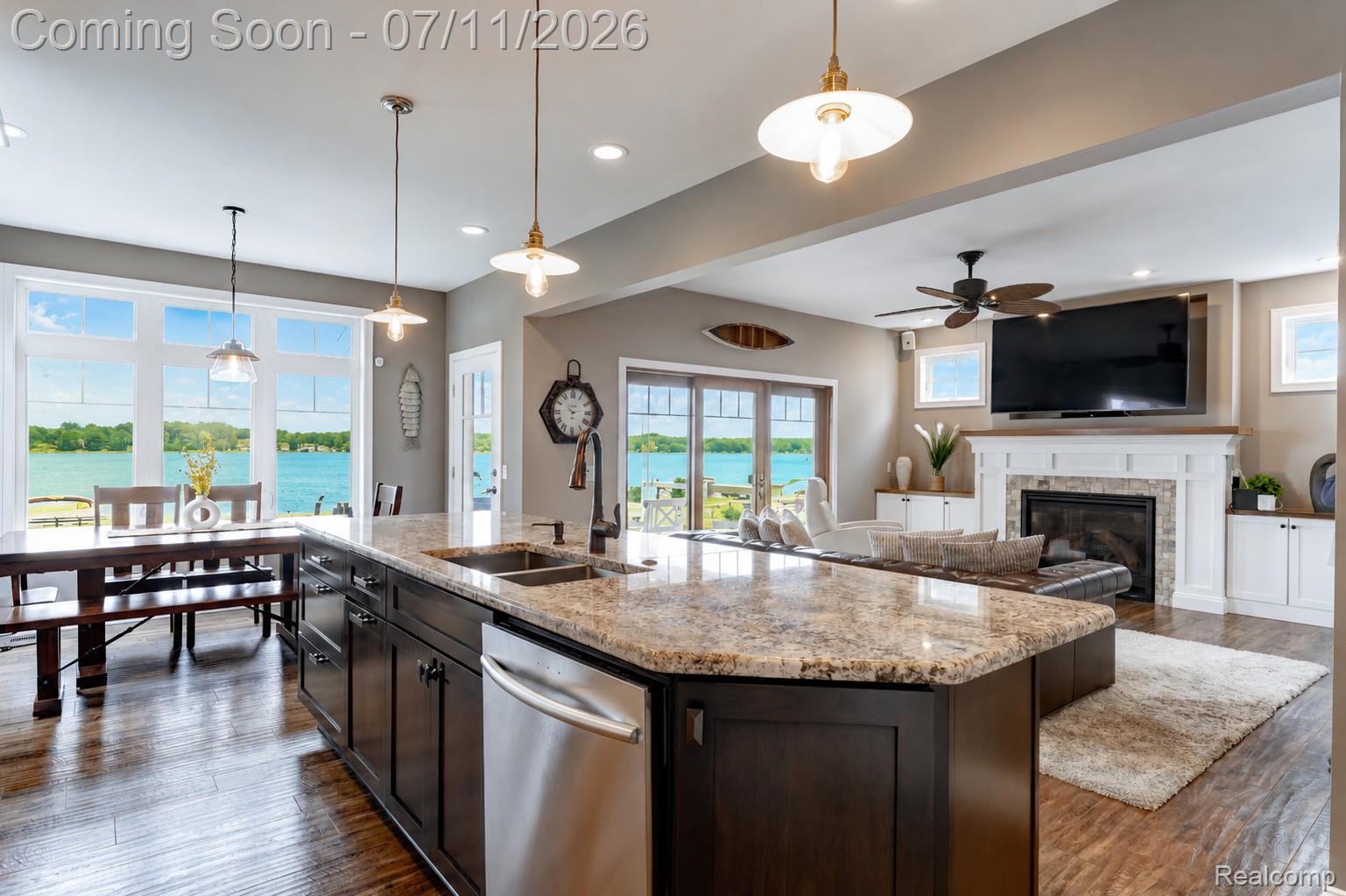 12033 Torrey Road Fenton, MI 48430 - Photo 16 of 51 Kitchen island with stone countertop and integrated double sink, wood-finish flooring, recessed lighting, and pendant fixtures