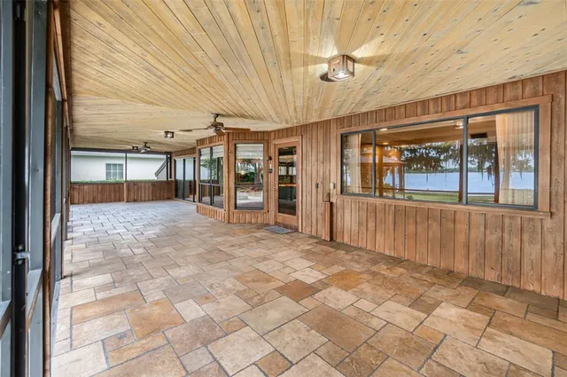 a view of a porch with a table and chairs