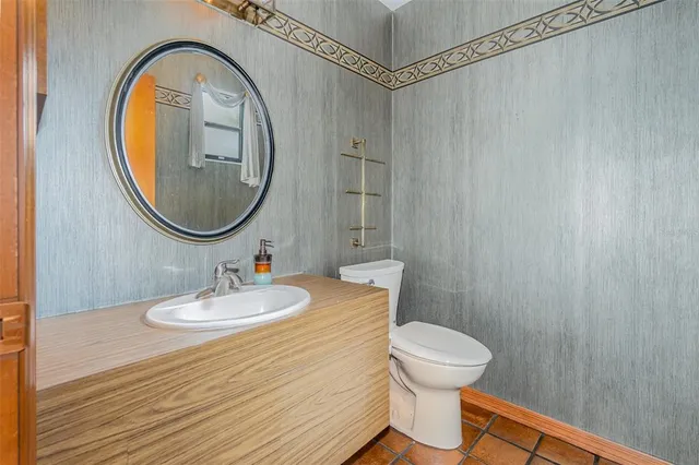 a bathroom with a sink a mirror and a toilet