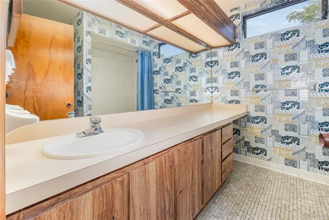 a bathroom with a sink and a mirror