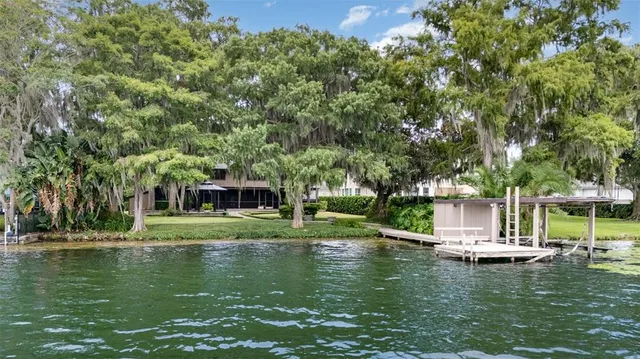 a view of a lake with a house in the background