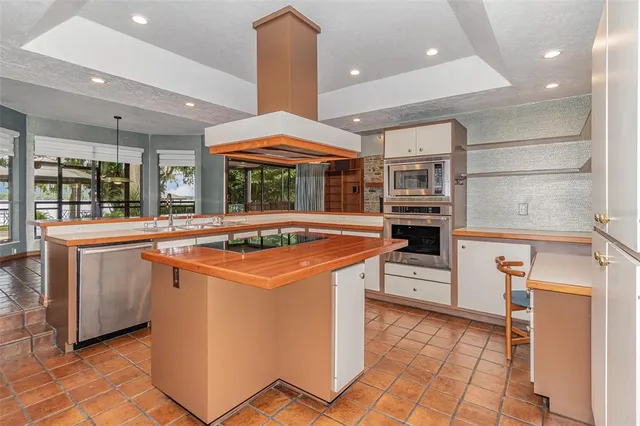 a kitchen with stainless steel appliances granite countertop a stove and a refrigerator