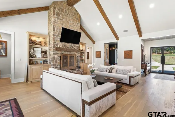 a living room with fireplace furniture and a flat screen tv