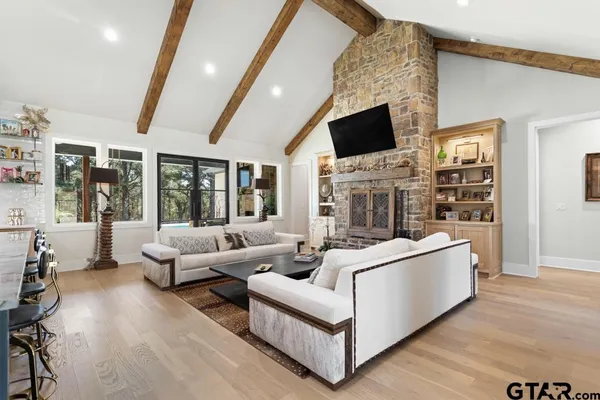 a living room with furniture white walls and a flat screen tv