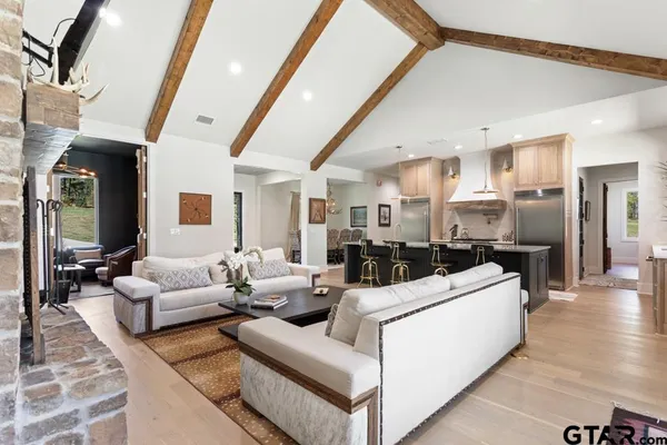 a living room with furniture and flowers