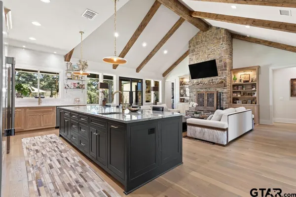 a spacious bathroom with a bathtub and chandelier