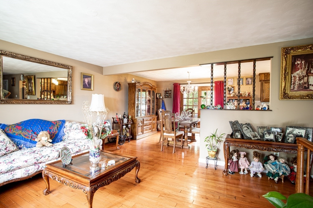 166 Stonehaven Road Fall River, MA 02723 - Photo 5 of 33 a living room with furniture a rug and a floor to ceiling window