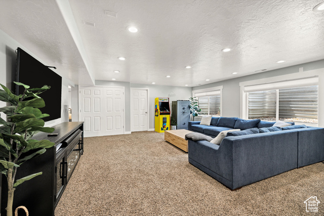 2280 South 450 West Perry, UT 84302 - Photo 28 of 38 Living area featuring light carpet, a textured ceiling, and recessed lighting