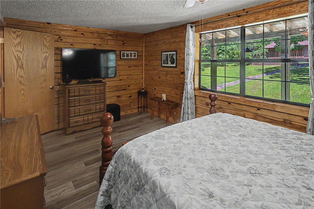 21019 Carter Road West Fork, AR 72774 - Photo 33 of 49 Room featuring horizontal wood paneling and wood-finish flooring
