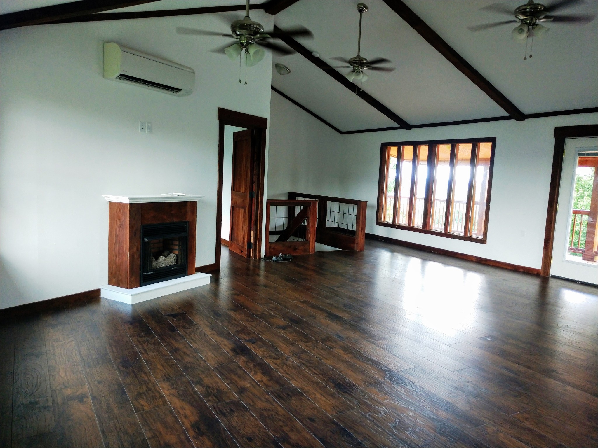 935 Poplar Flatt Road Silver Point, TN 38582 - Photo 23 of 33 an empty room with wooden floor fireplace and windows