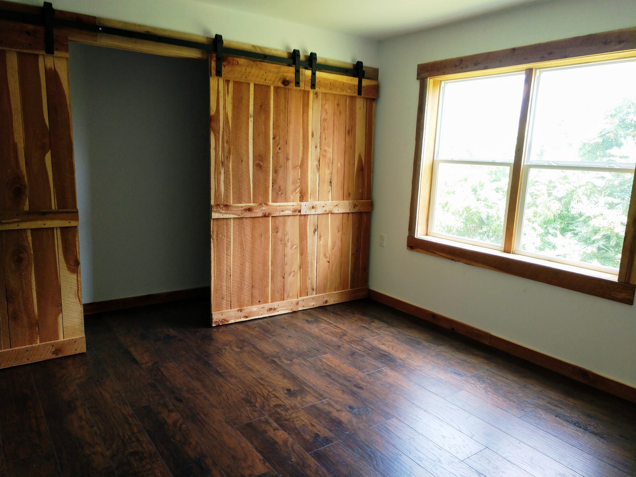 935 Poplar Flatt Road Silver Point, TN 38582 - Photo 9 of 33 a view of an empty room with wooden floor and a window