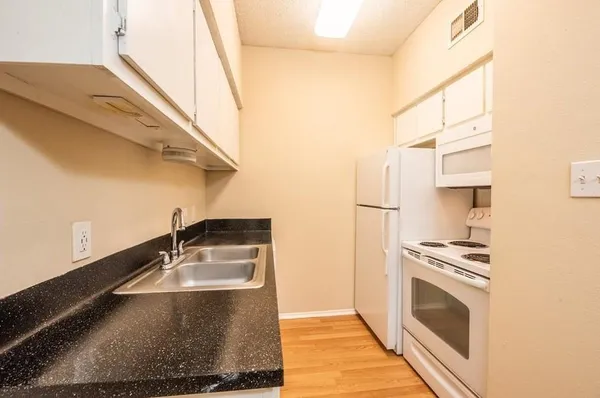 a kitchen with a sink cabinets and stainless steel appliances